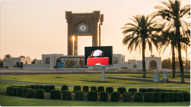 A large sign in front of a building
Description automatically generated