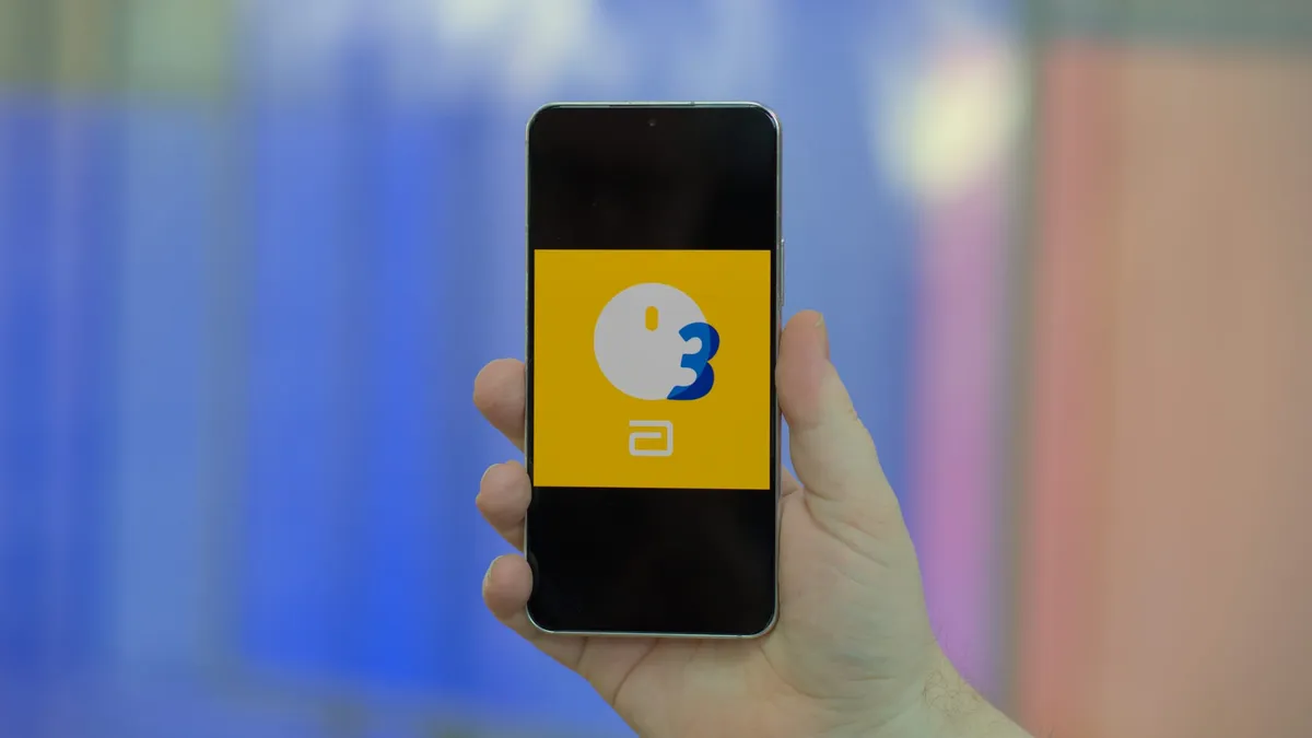 A Samsung Galaxy smartphone showing the Abbott FreeStyle Libre 3 app icon on screen.