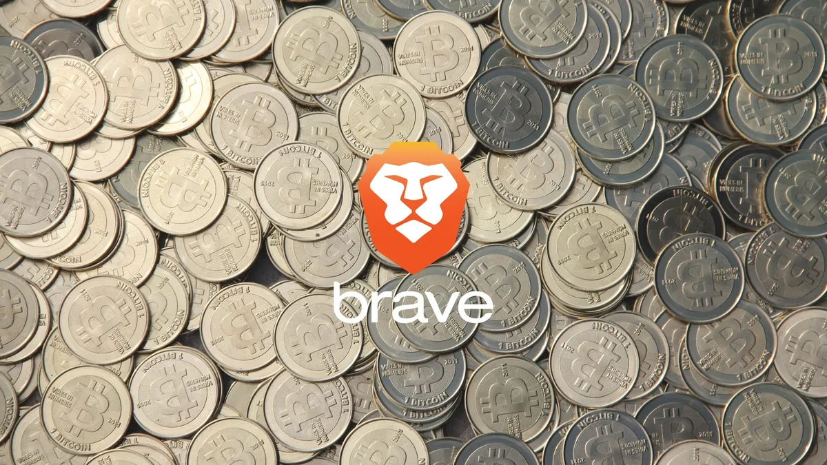 The Brave logo in front of a pile of Bitcoin tokens.