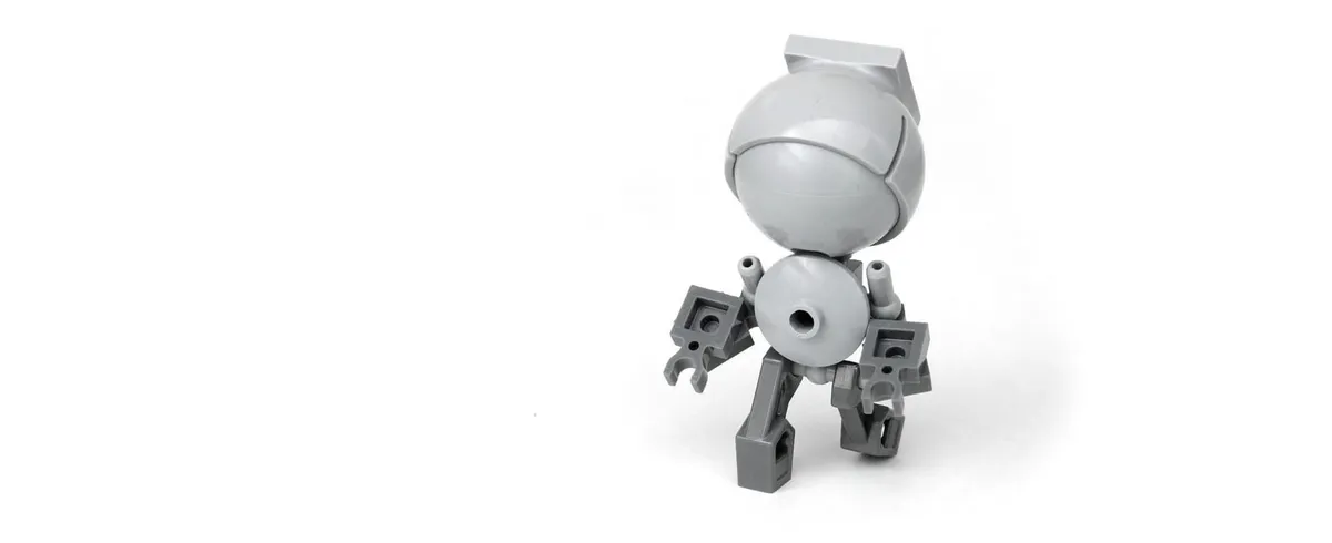 A small robot with a large head made out of Lego bricks.