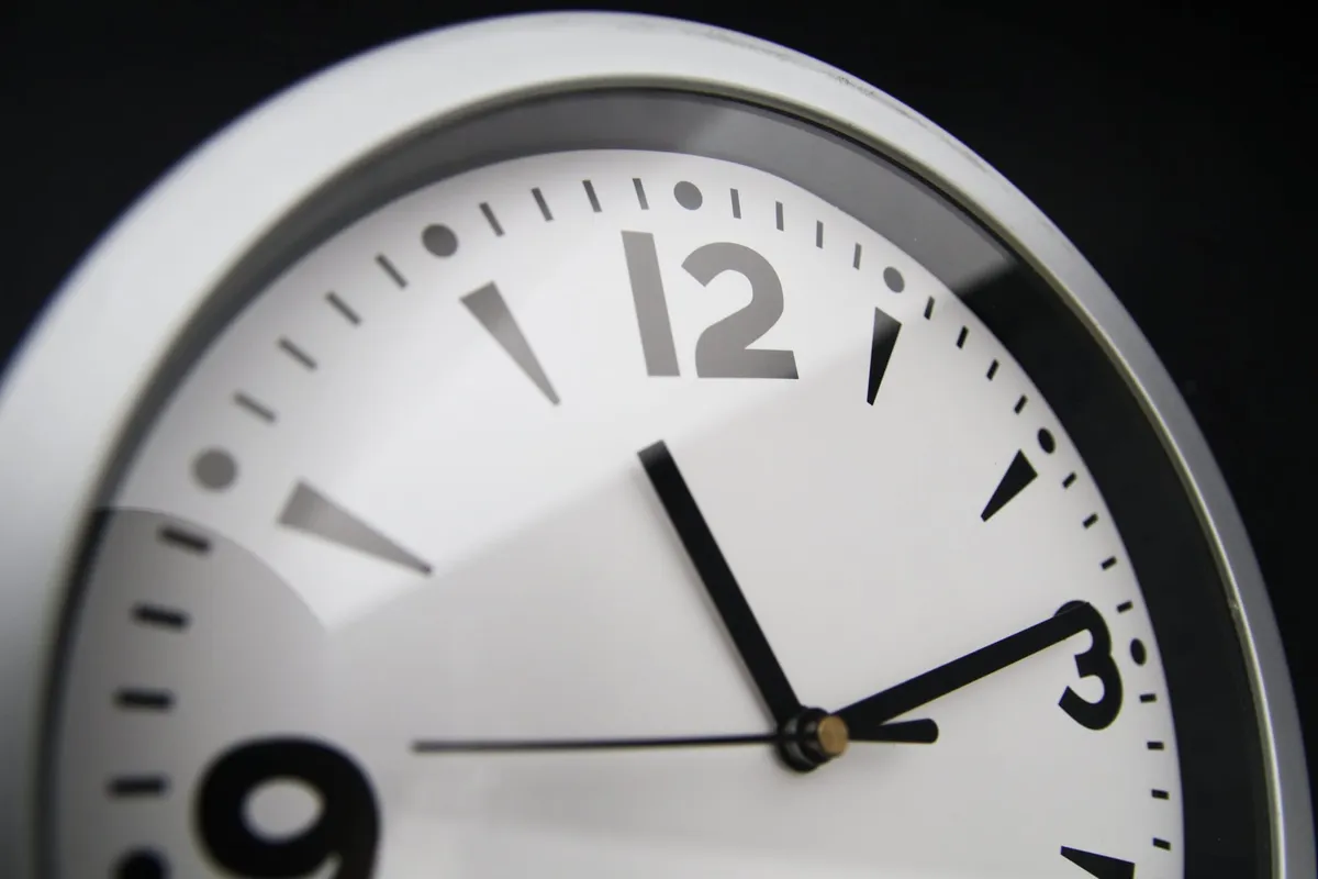 A close-up of a wall clock at 11:08.