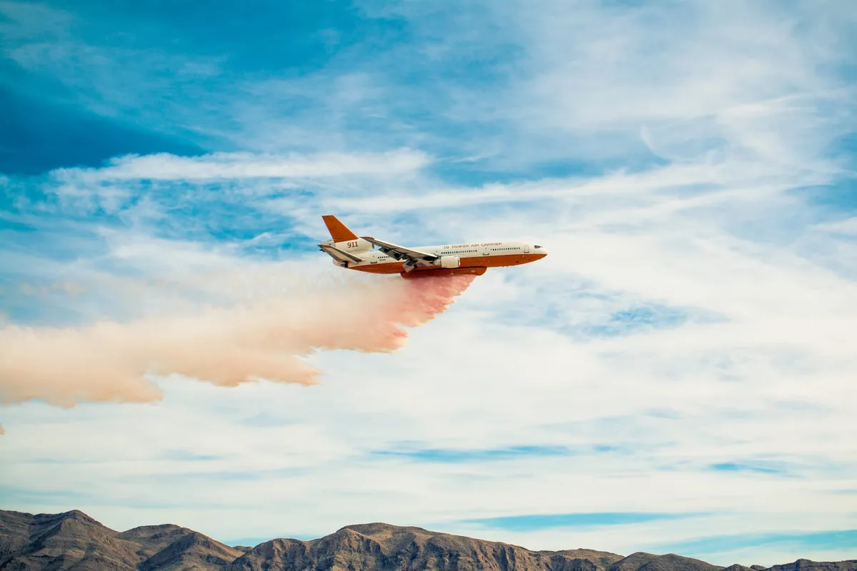 A plane dumping its firefighting foam cargo.