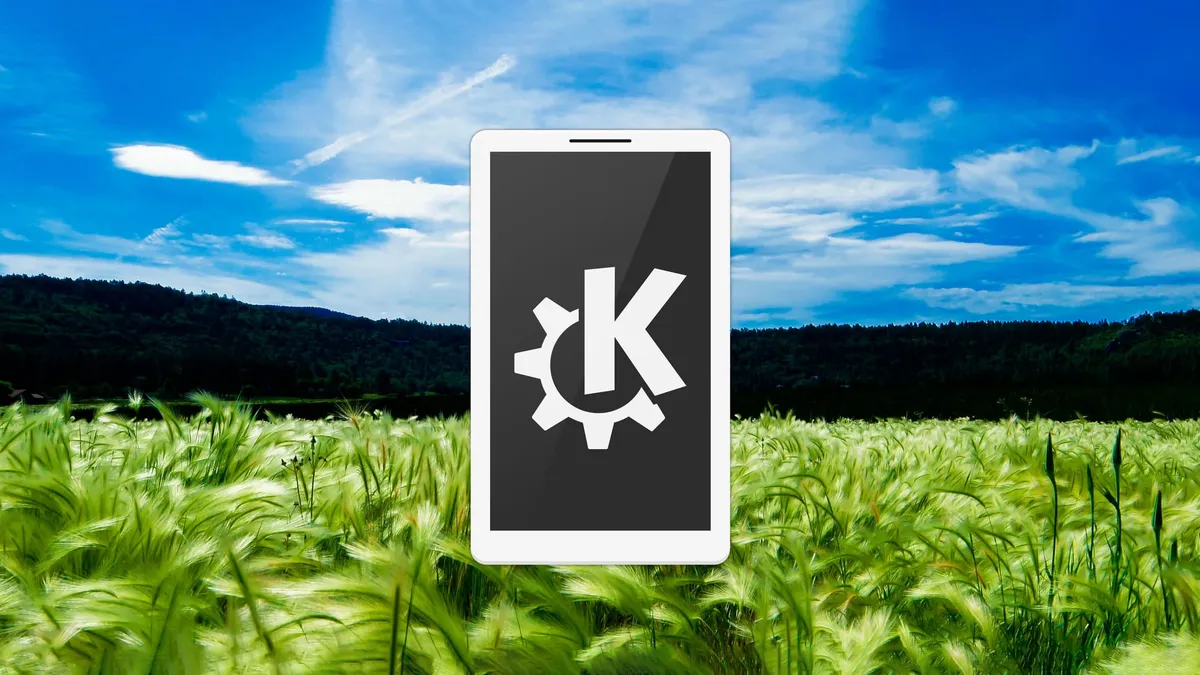 A smartphone with the KDE logo on the screen hovering above a wheat field.