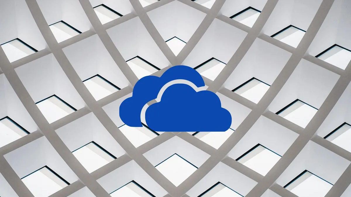 The OneDrive logo in front of an abstract background featuring a grid of compartments.
