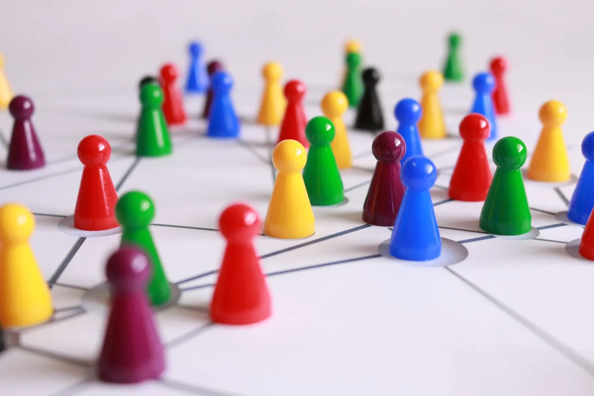 Multicolored game pieces on a game board.
