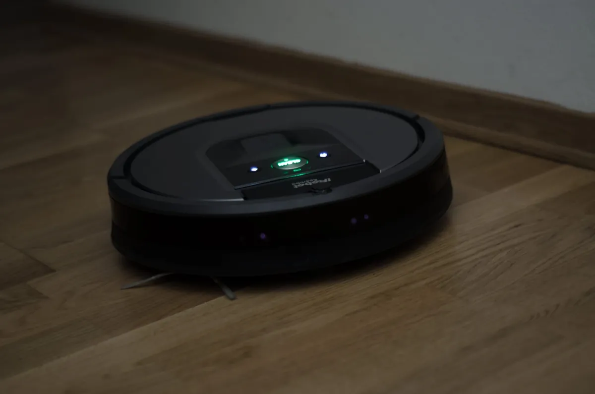 A Roomba 960 cleaning the floor in the dark.