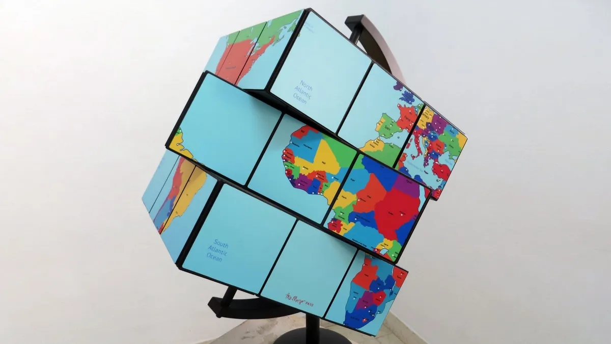 A square globe world-map shaped like a Rubik’s cube.