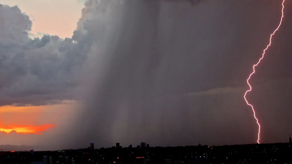 A lightning bolt strikes the ground in the distance during a rainy thunderstorm.
