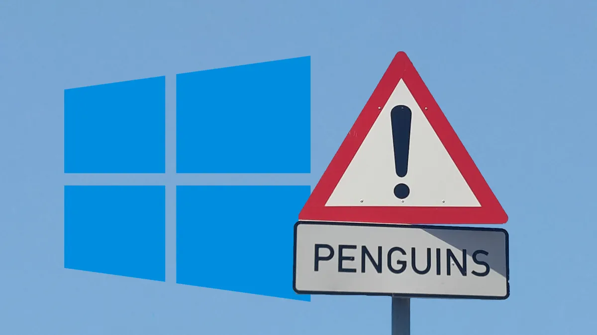 A clear sky with the Windows logo partially covered by a warning sign labeled “Penguins!”