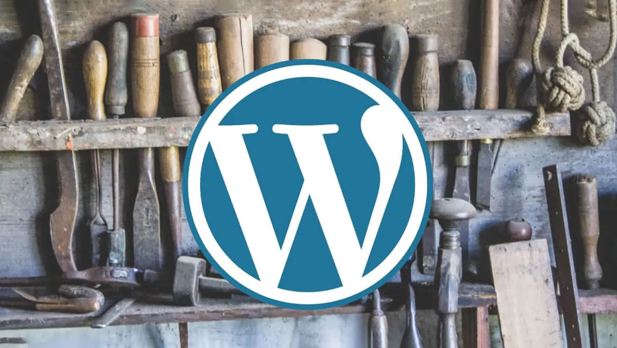 The WordPress logo with a full tool rack in the background.