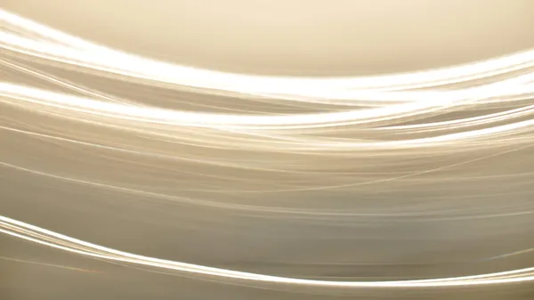 Abstract light stripes against a beige background.