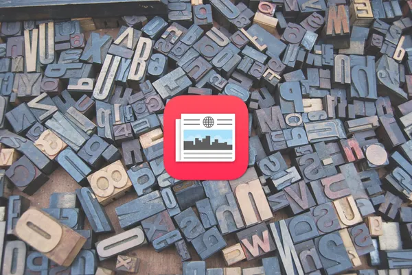 The Apple News app icon in front of typesetting letters.