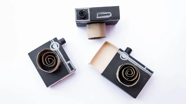 Three cameras made out of cardboard.