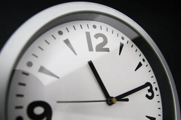 A close-up of a wall clock at 11:08.