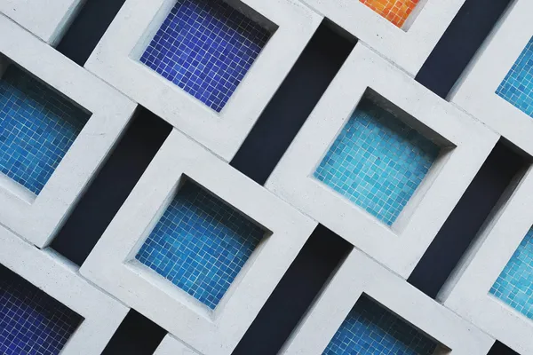 A set of concrete squares with colored titles inside.