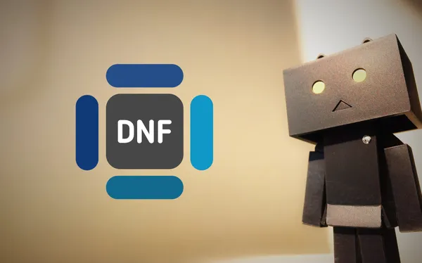 A toy robot looking at the DNF logo.