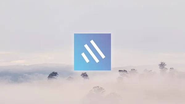 The Topical logo in front of a forest covered by fog.