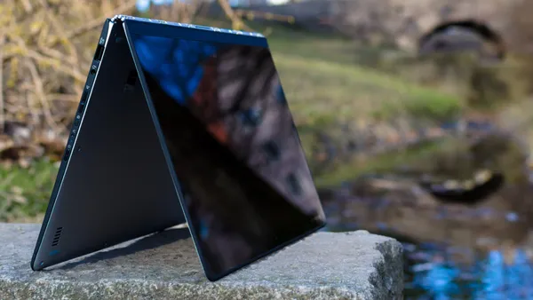 A Lenovo Yoga 3 Pro laptop folded back on itself into tent mode with the touch screen facing outwards.