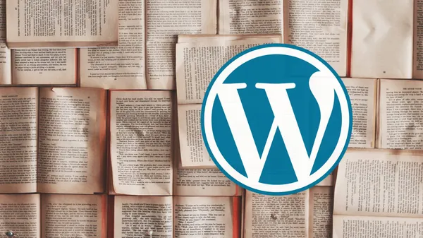 The WordPress logo in front of a backdrop of open books.