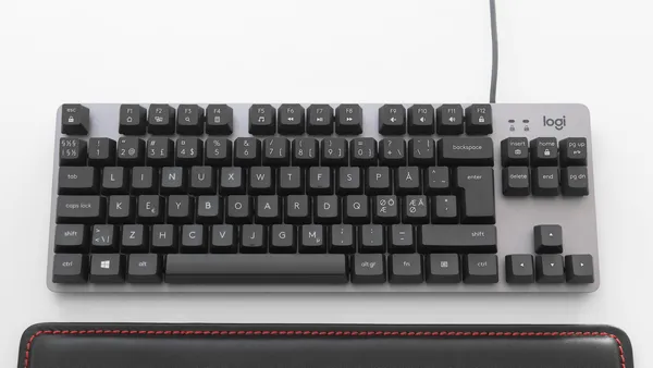 A Logitech-brand mechanical tenkeyless (TKL) keyboard with the keycaps rearranged to spell out “Linux keyboard.”