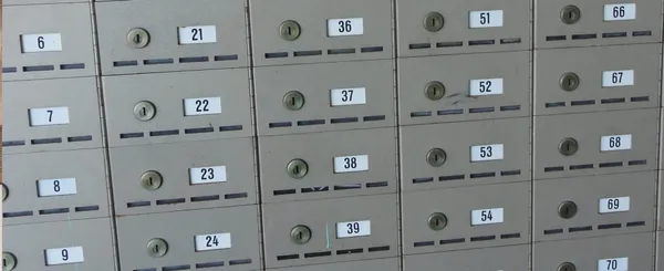 A wall of numbered locked boxes.