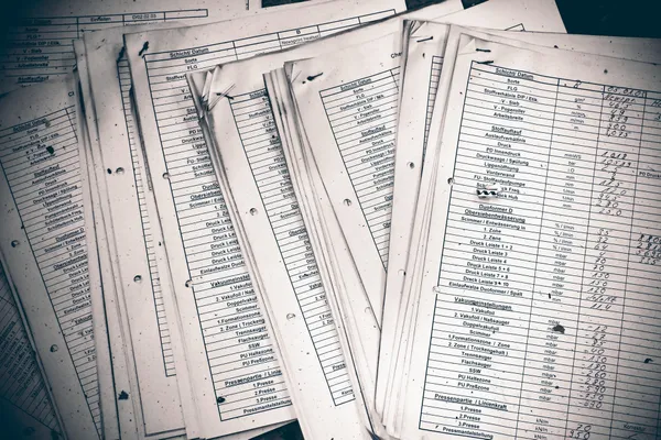 Worn paper ledgers.