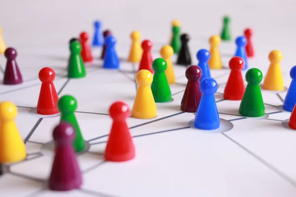 Multicolored game pieces on a game board.