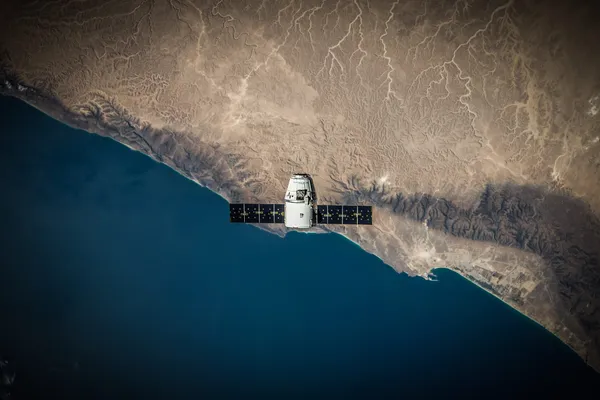 A SpaceX Dragon Capsule in orbit above Earth.