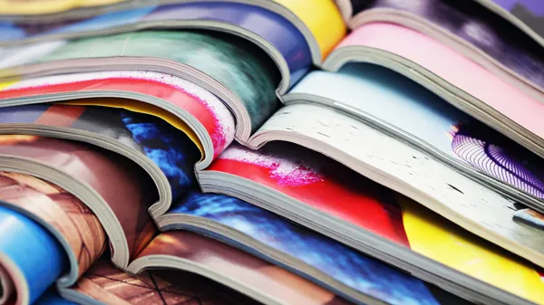 A stack of open magazines.