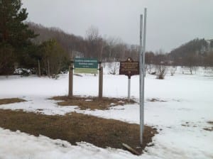 Posts for new MDOT road signs on M-22 seem set to obscure the new signs for the Elberta Dunes South Natural Area.