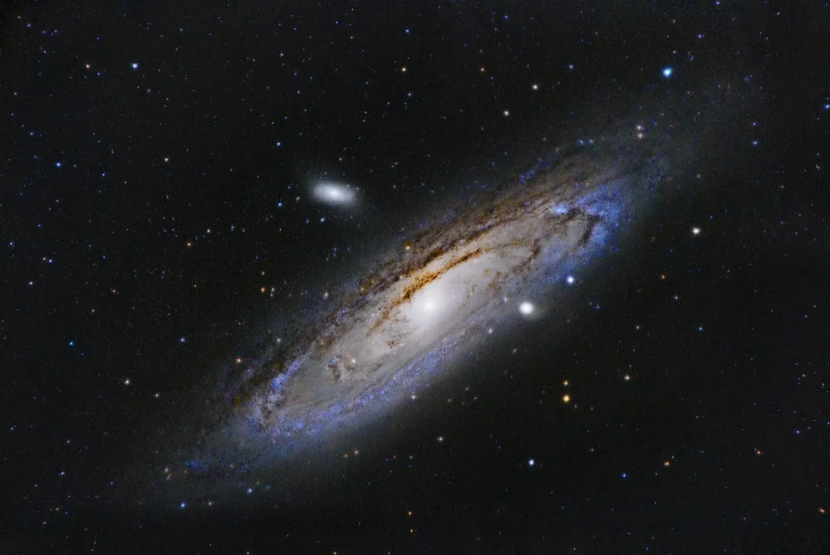 Spiral galaxy with a bright central core and visible dust arms in deep space.