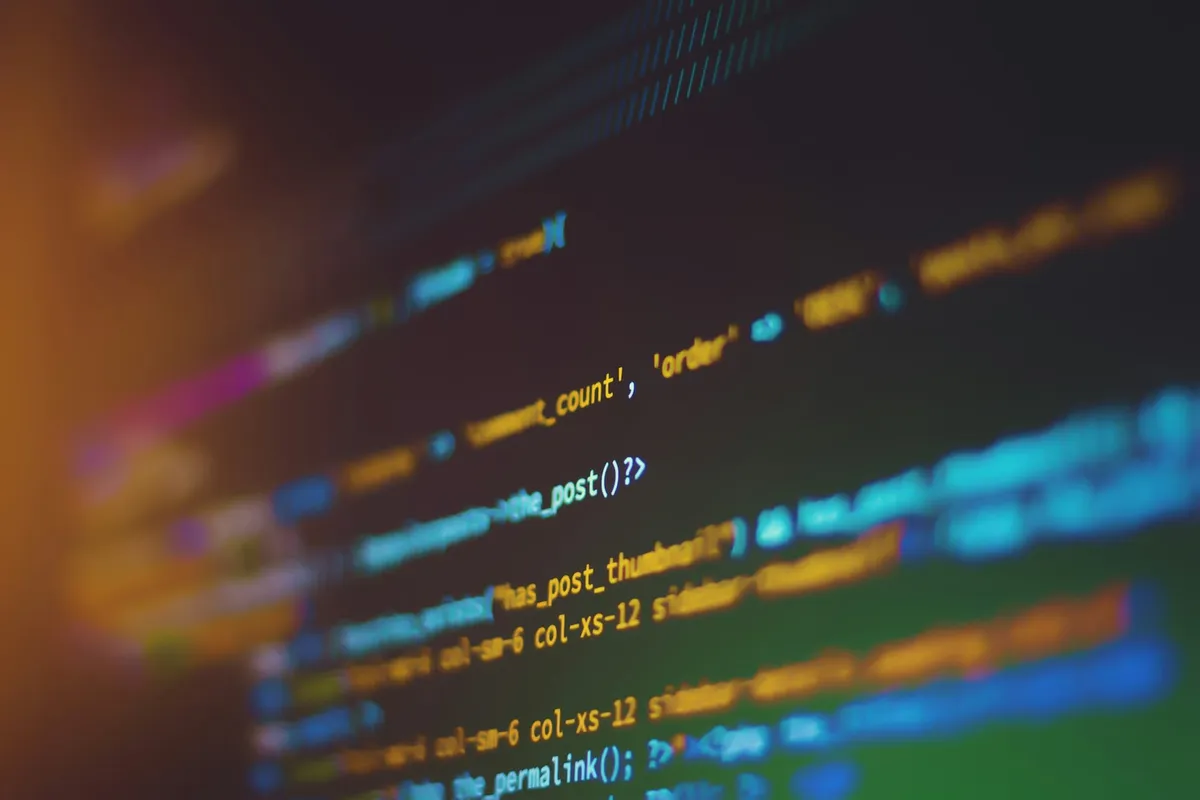 Close-up of computer code displayed on a screen with shallow depth of field.