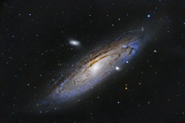 Spiral galaxy with a bright central core and visible dust arms in deep space.