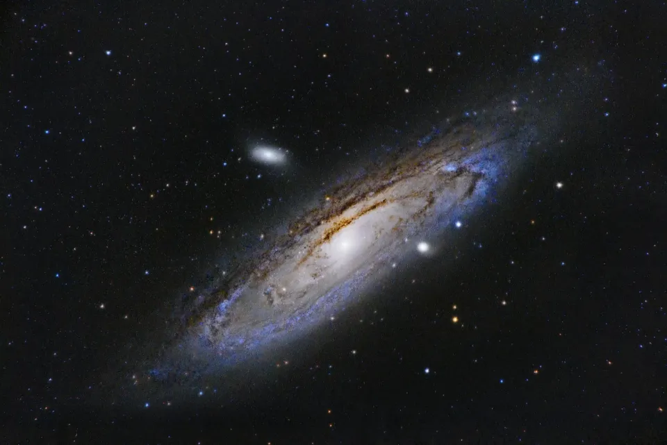 Spiral galaxy with a bright central core and visible dust arms in deep space.