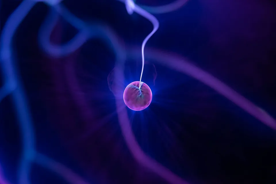 Glowing red sphere of light against a dark background with a soft halo effect.