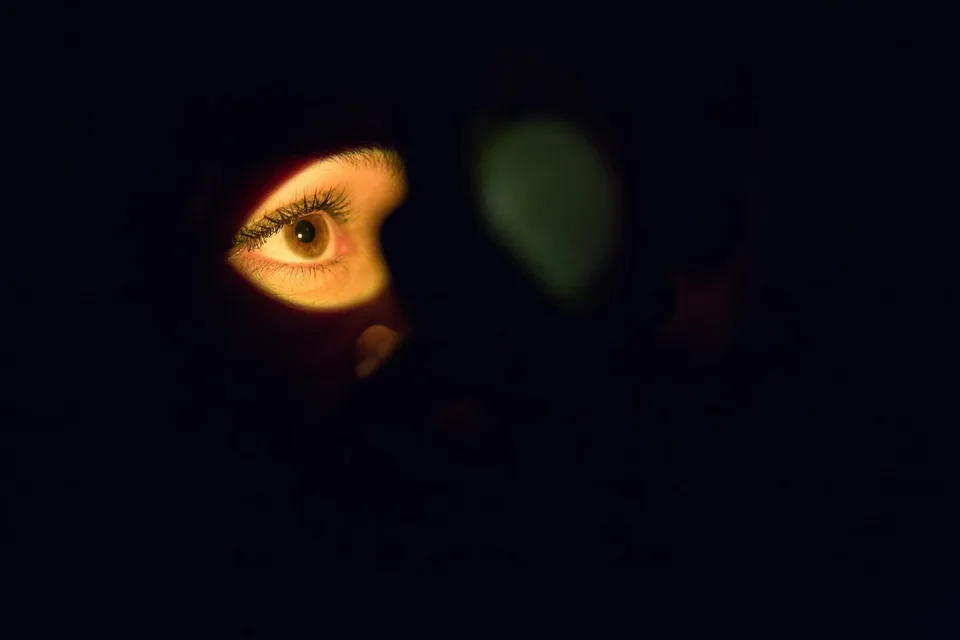 Close-up of a woman’s face focusing on green eyes and facial expression.