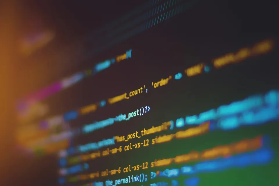 Close-up of computer code displayed on a screen with shallow depth of field.