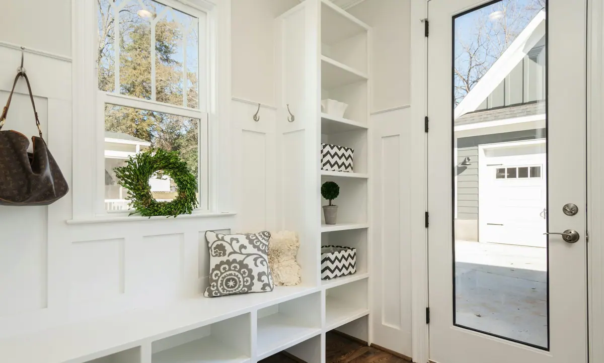 gray and white floral throw pillow beside rack inside room