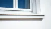 Gros plan d'une base de fenêtre moderne rencontrant le mur extérieur