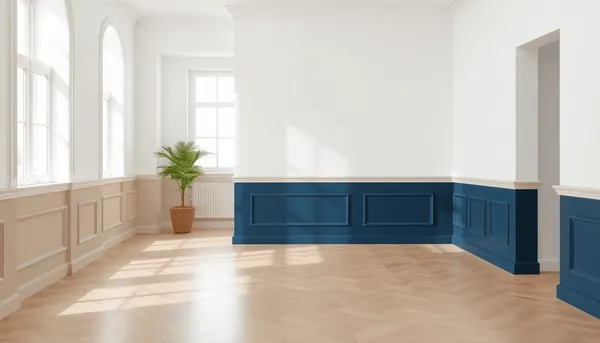 Chambre moderne et lumineuse avec des murs blancs et des plinthes élégantes en gris, beige et bleu marine