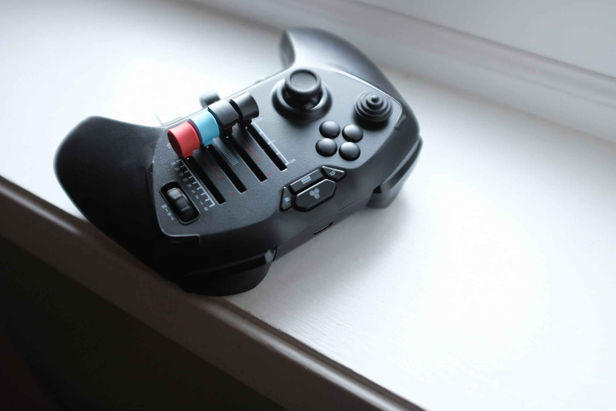Honeycomb Echo Aviation Controller — the handheld flight deck with thumbstick, sliders, and trim wheel