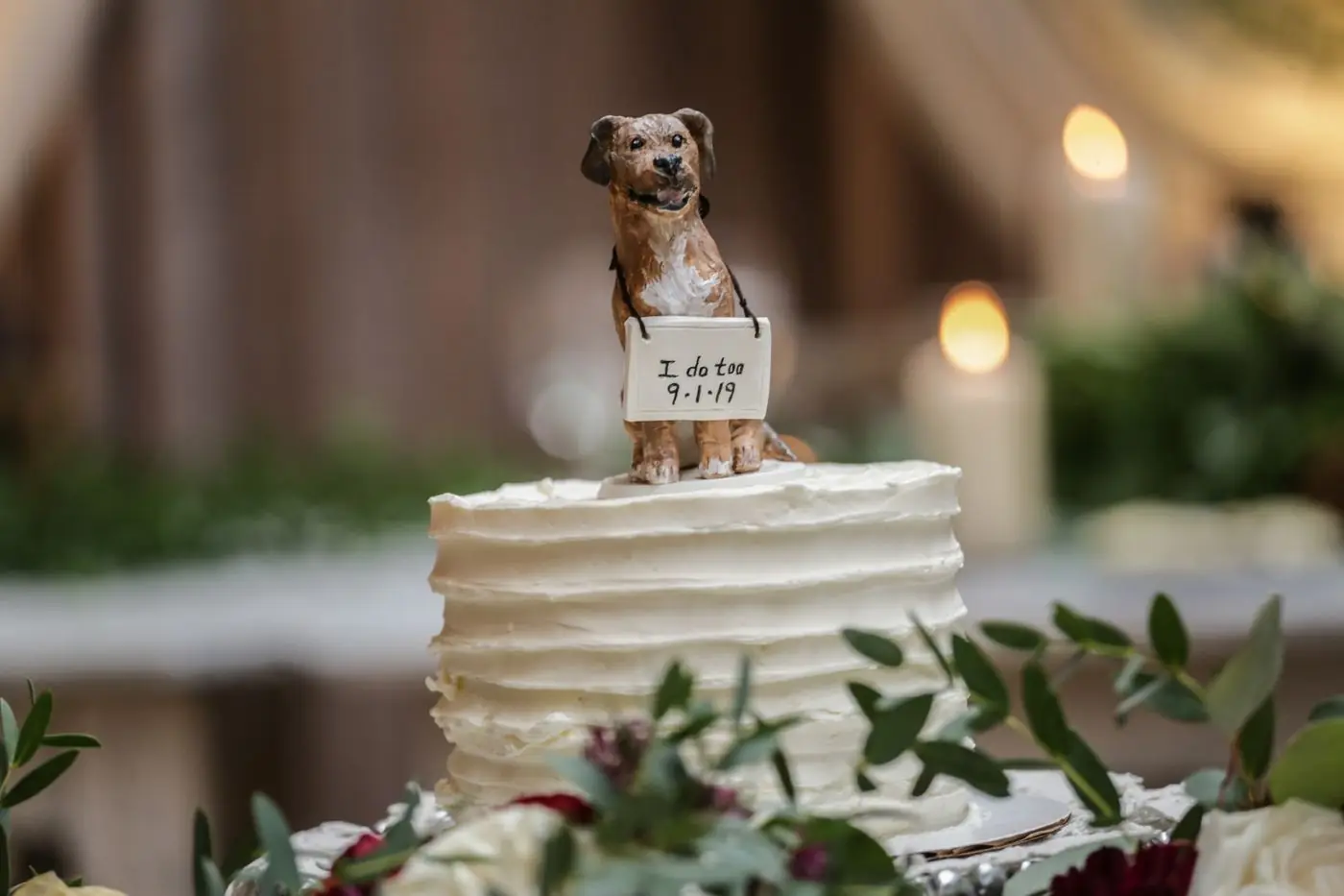Beautiful wedding cake with a dog figurine topper, ideal for unique weddings. Shot indoors in Chicago.