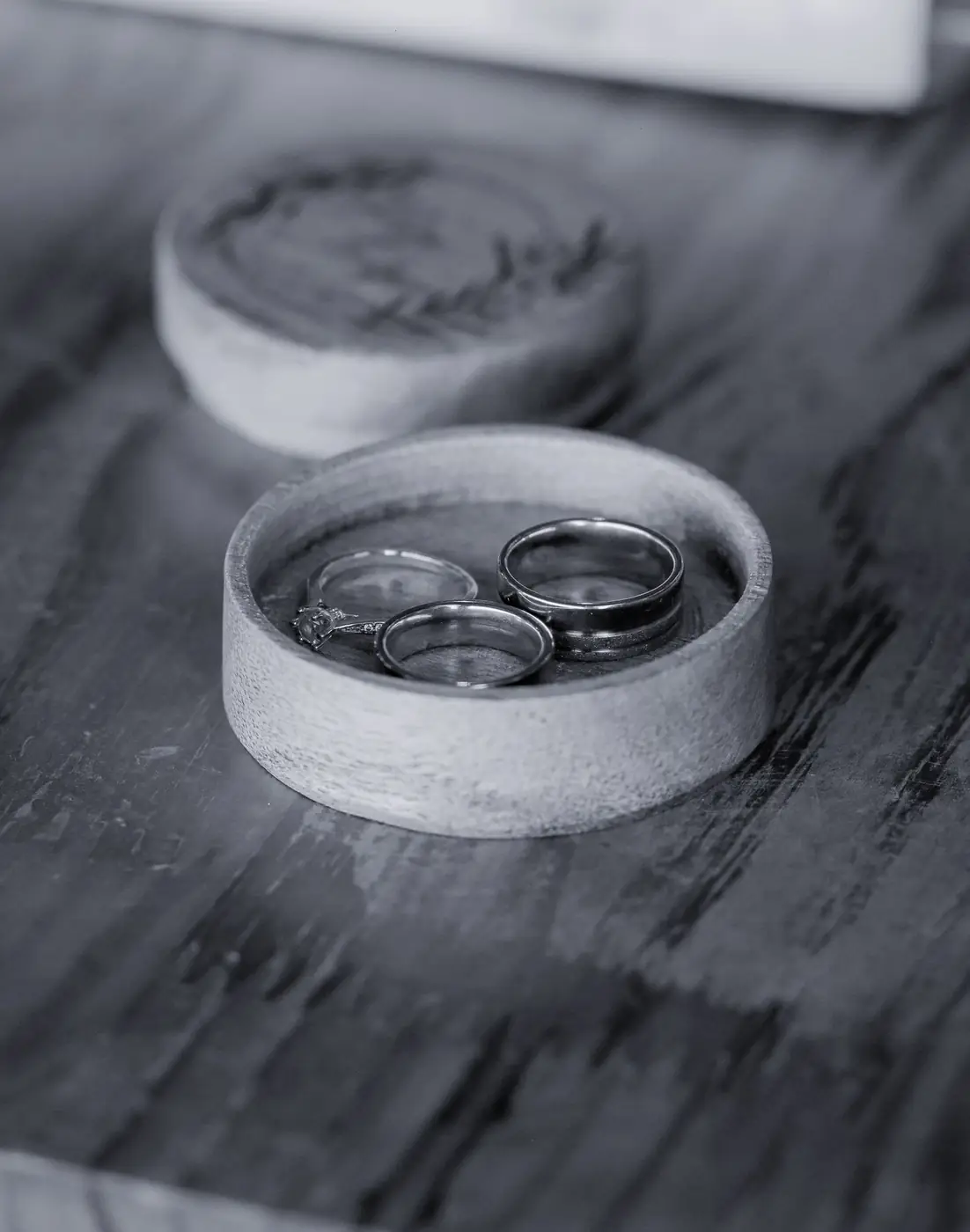 Close-up of luxurious wedding rings in an intricately crafted wooden box, perfect for a ceremony.