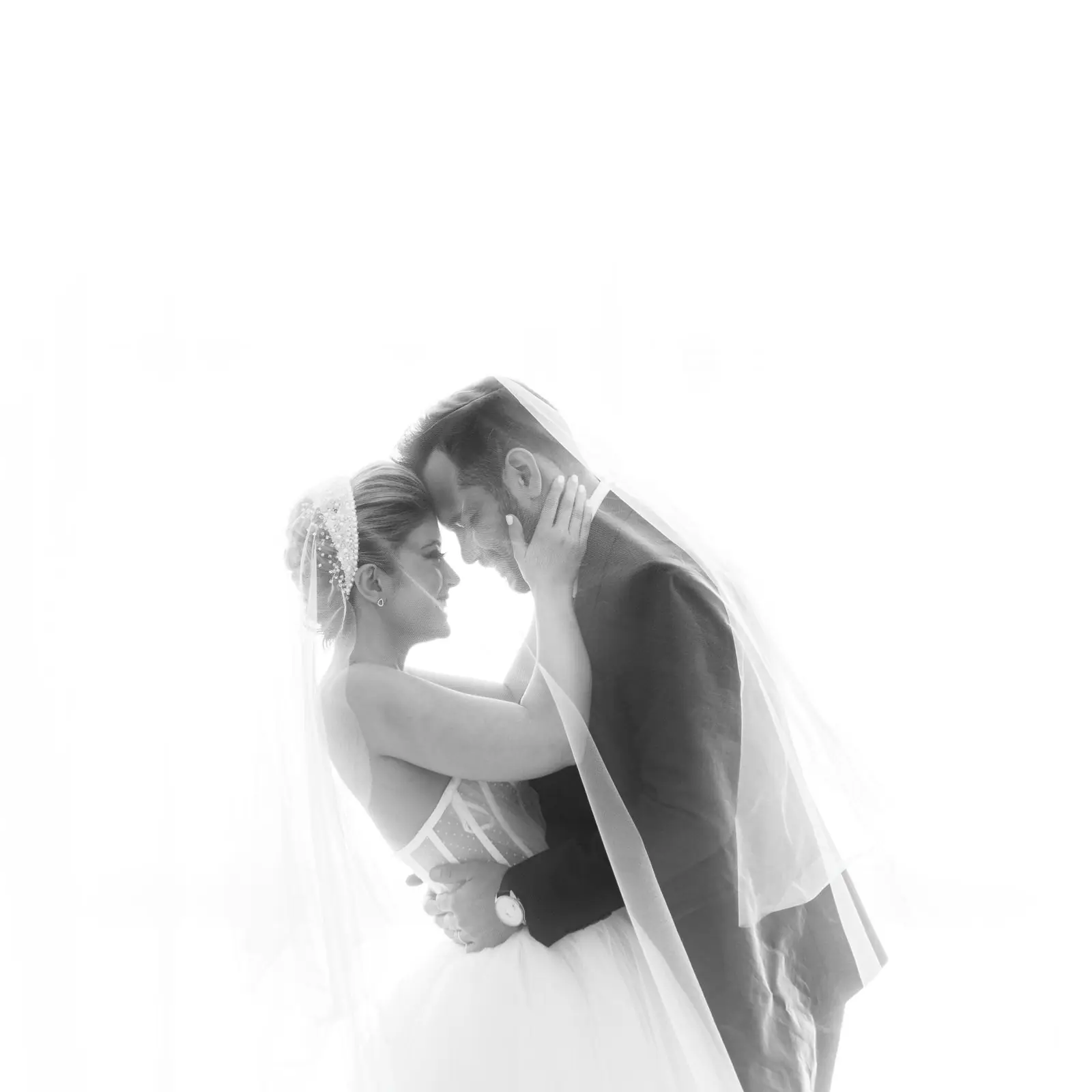 Close-up of a couple exchanging vows during a wedding ceremony outdoors.