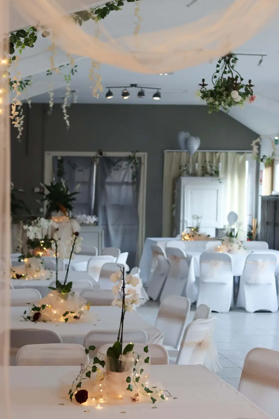 Beautiful indoor wedding setup with floral arrangements and elegant lighting, perfect for celebrations.