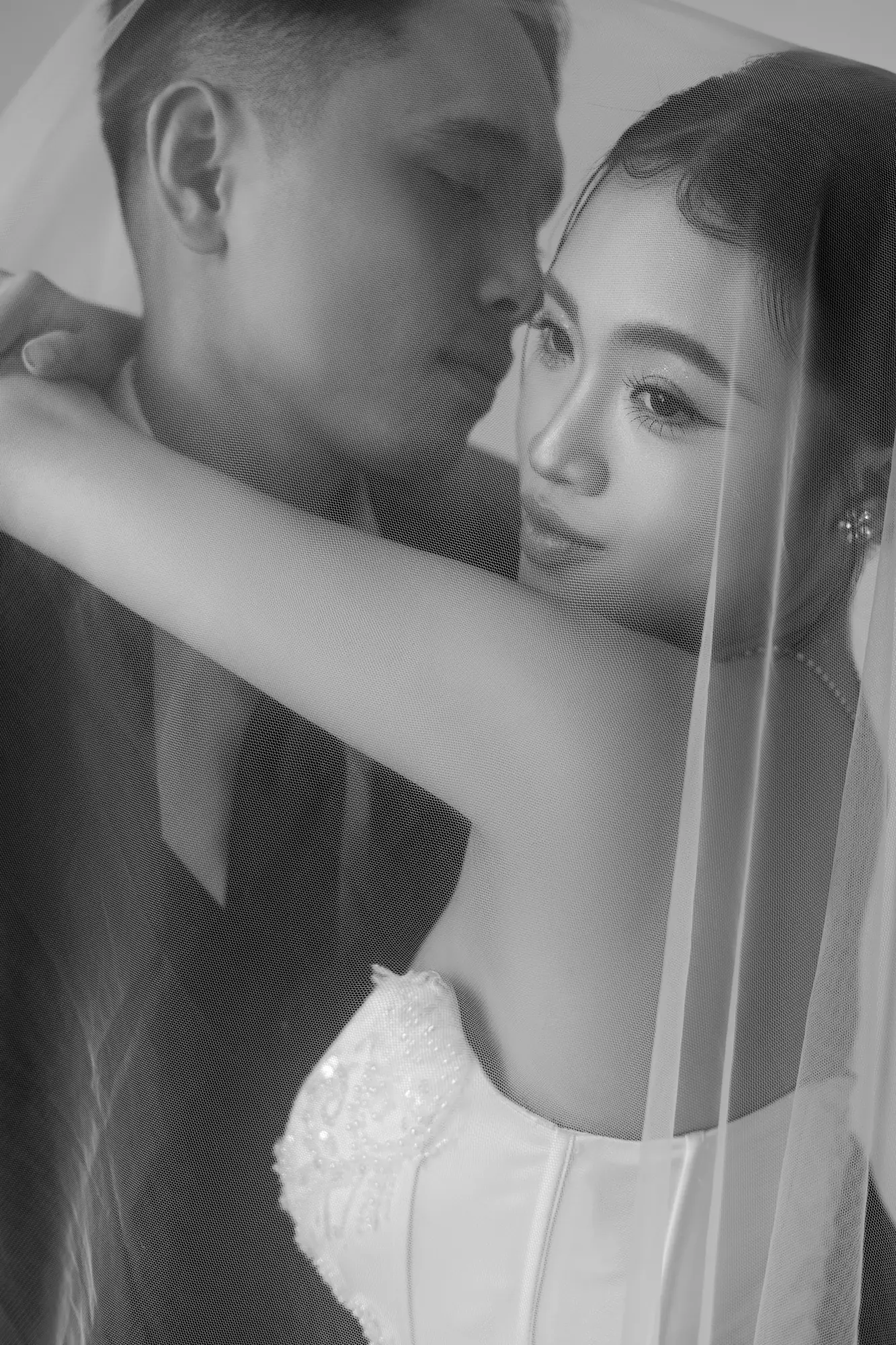 Intimate black and white portrait of a bride and groom on their wedding day.