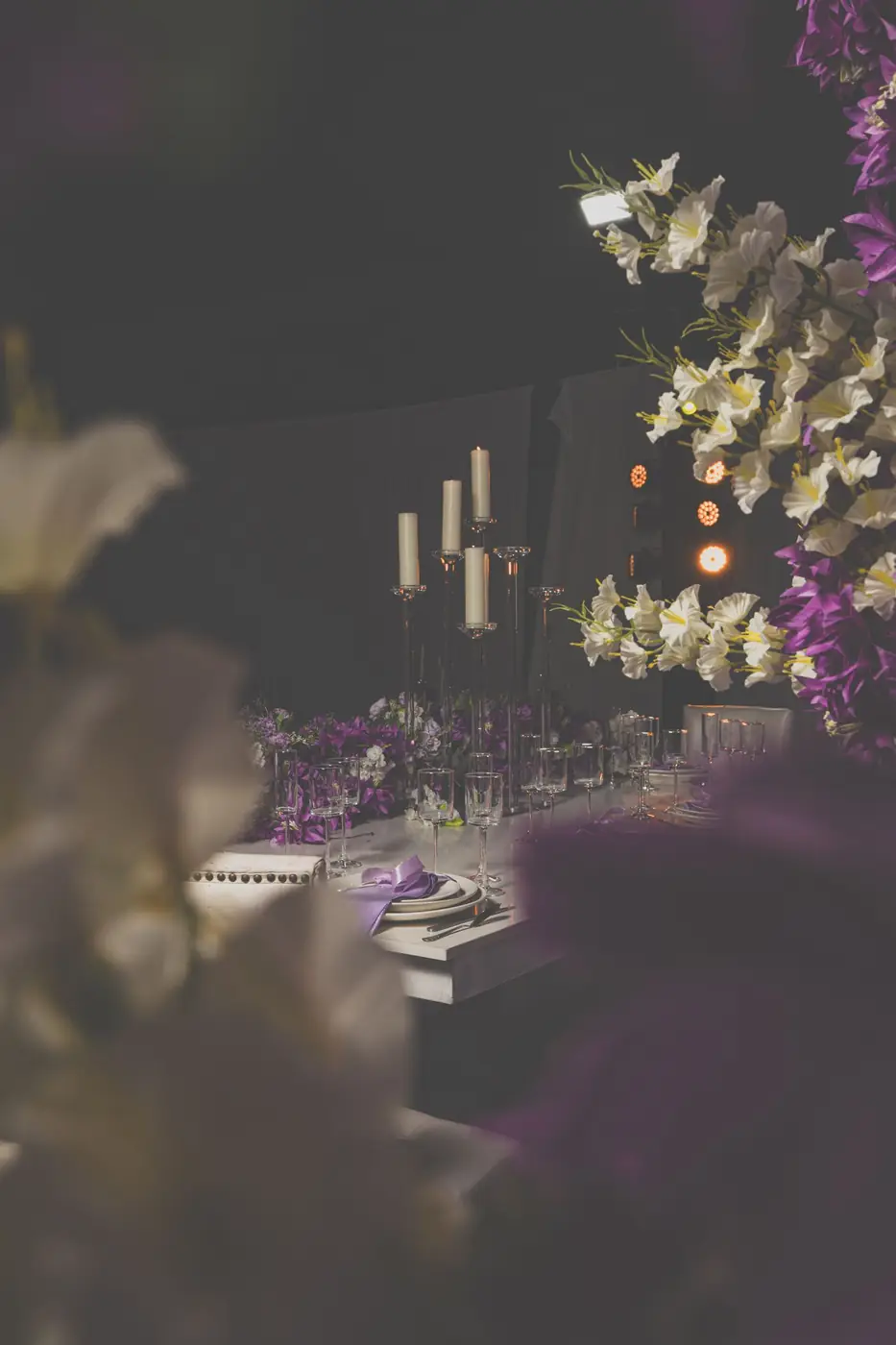 Luxurious dining setup with candles and floral decor, perfect for weddings and formal events.
