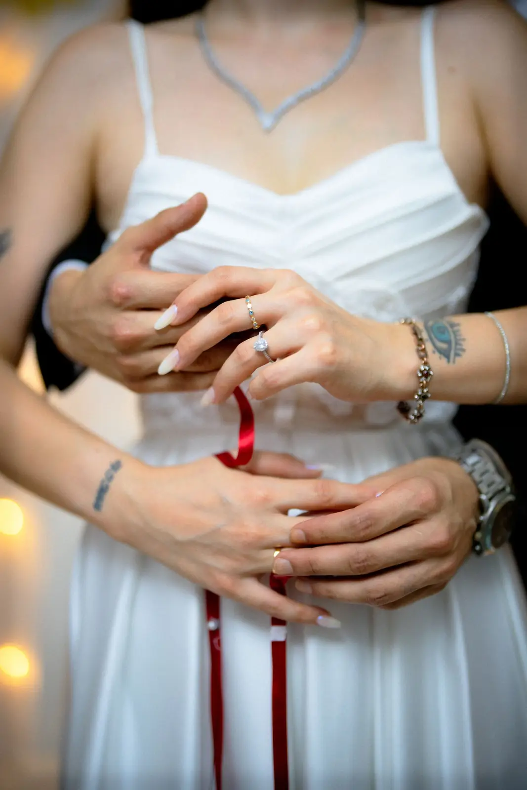 Newlywed couple embracing tenderly, capturing intimate wedding moment indoors.