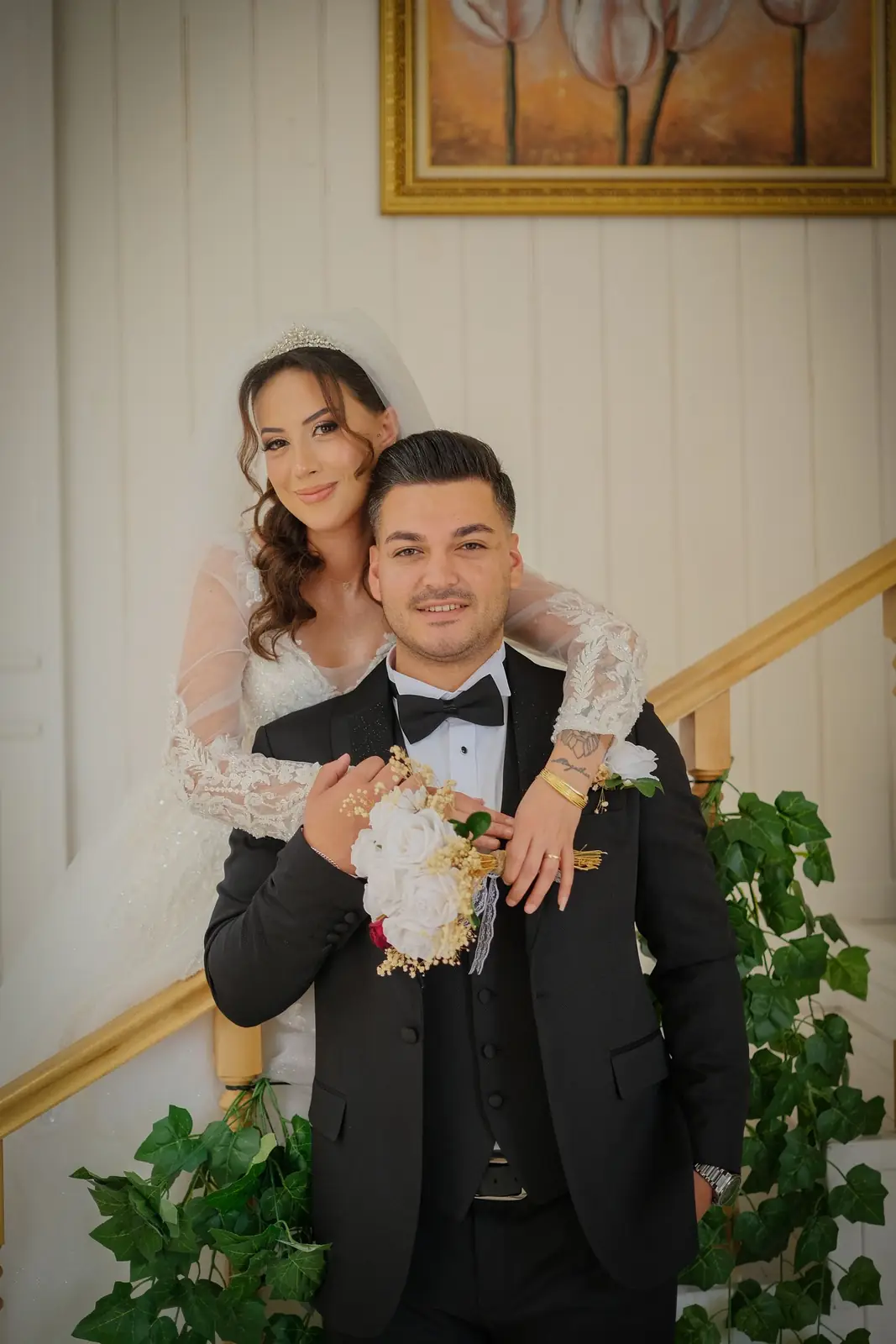 Elegant couple kissing in an elevator, capturing a romantic wedding moment.