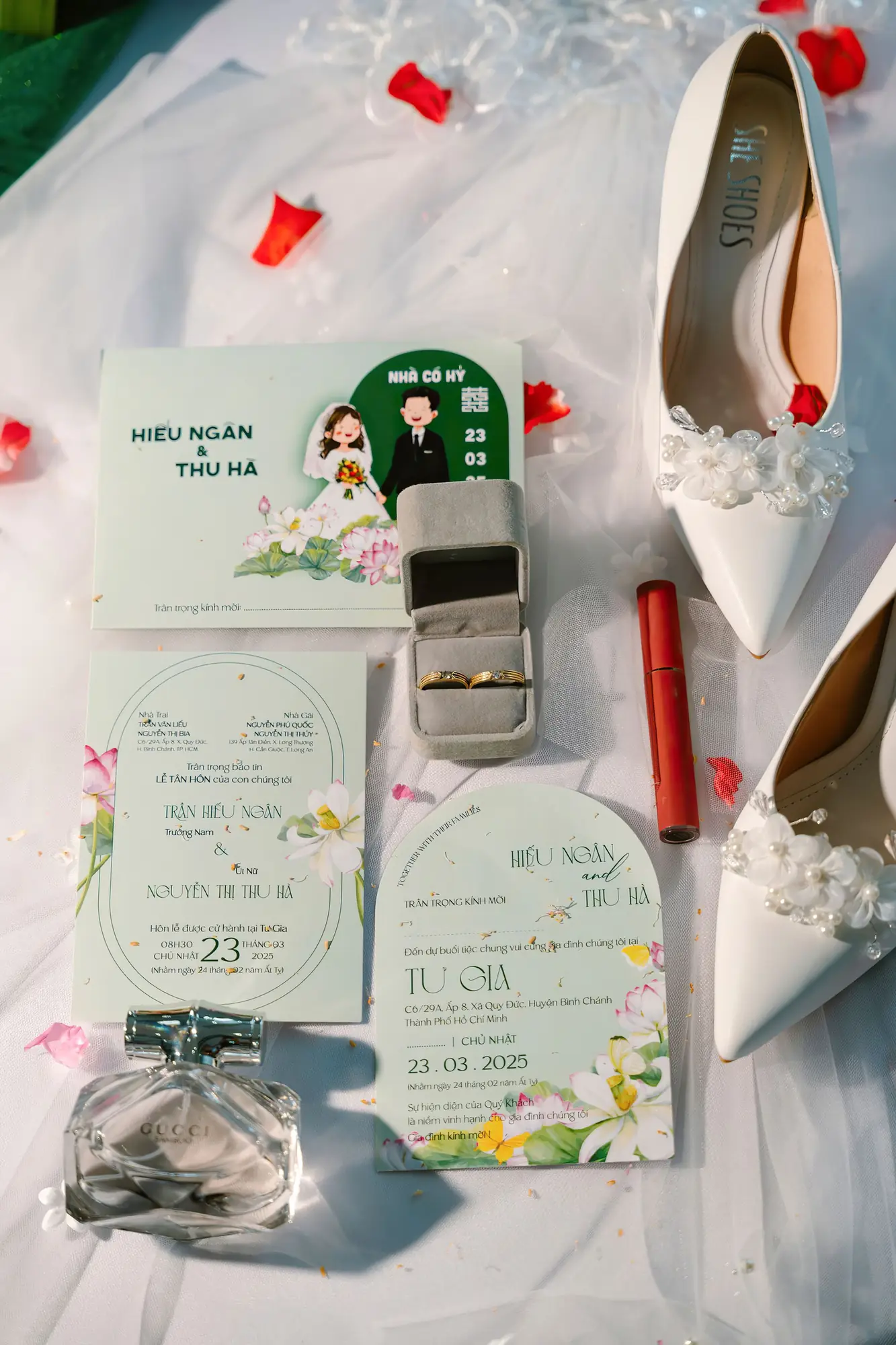 Charming flat lay of wedding invitations and accessories with floral accents in Vietnam.
